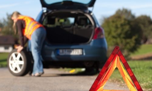 Safety Whilst Driving - Picture of a warning triangle and an open car boot